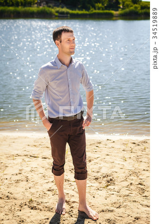 young man walking on cost river 34519889