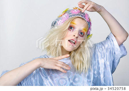 Young girl with colorfull makeup in sparkling hat 34520758