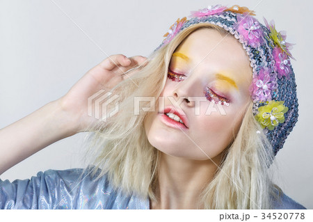 Young girl with colorfull makeup in sparkling hat 34520778
