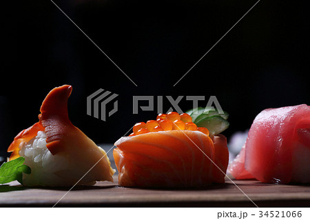 Sushi Set sashimi and sushi rolls with tea on wood background Sushi Set sashimi and sushi rolls with tea on wood background 34521066