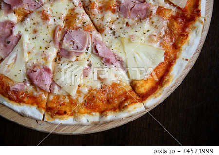 pizza hawaiian , pizza with pineapple and ham with cheese and tomatoes sauce on wood background , italian food pizza hawaiian , pizza with pineapple and ham with cheese and tomatoes sauce on wood background , italian food 34521999