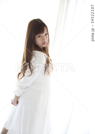 Asian young woman wake up with pillow in white room 34522107