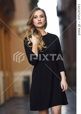 Beautiful blonde russian woman in urban background Beautiful blonde russian woman in urban background 34526561
