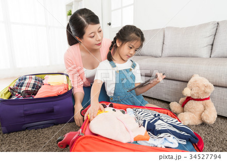 woman with lovely daughter using mobile computer 34527794
