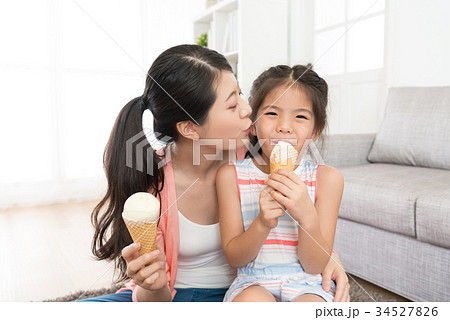 young mother kissing her lovely little daughter 34527826