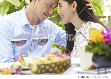 a young couple has a romantic lunch with wine a young couple has a romantic lunch with wine 34530960