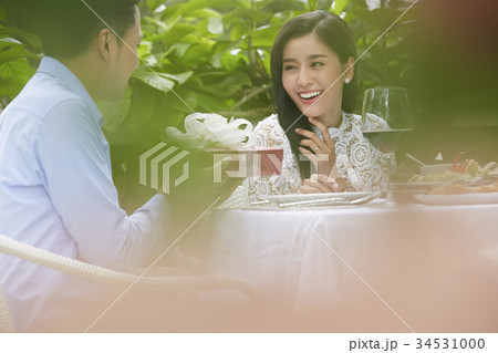 young man is giving a gift box to his girlfriend in a restaurant young man is giving a gift box to his girlfriend in a restaurant 34531000