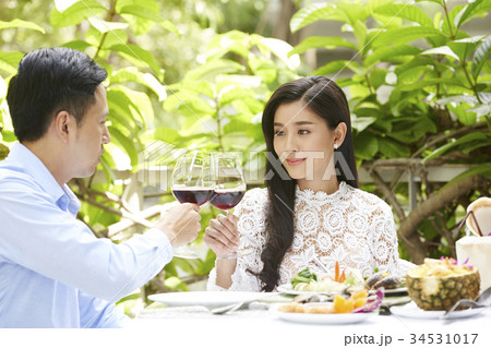 a young couple drinks wine and has lunch in a restaurant a young couple drinks wine and has lunch in a restaurant 34531017