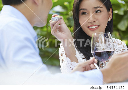 The woman is giving a spoon of food for the man happily The woman is giving a spoon of food for the man happily 34531122