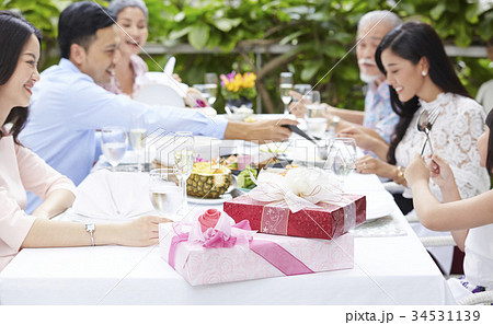 The family members are joking around the table very cheerful The family members are joking around the table very cheerful 34531139