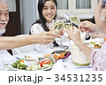 a young asian woman is having dinner and cheering up with family in a restaurant 34531235