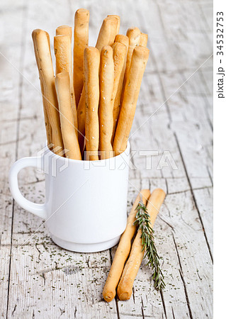 cup with bread sticks grissini and rosemary 34532753