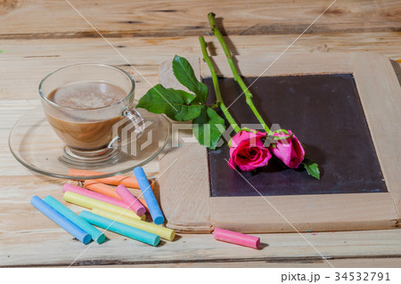 hot coffee on pinewood tabel with pastel 34532791