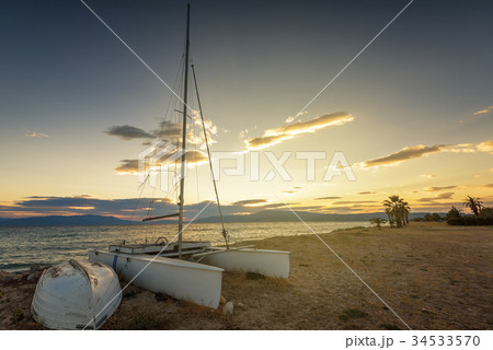 Sailboat on the beach at sunset 34533570