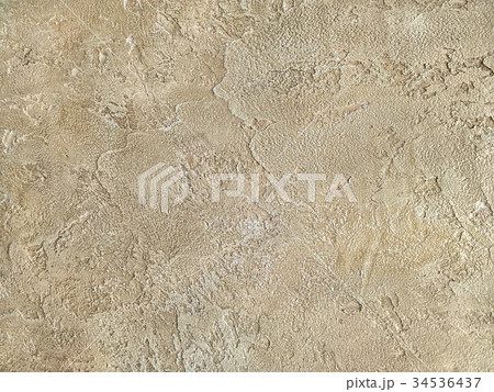 Old beige wall covered with uneven plaster. Old beige wall covered with uneven plaster. 34536437