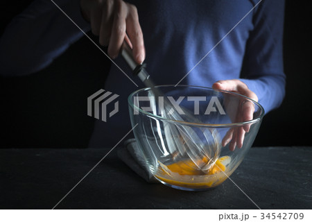 Beat yolks in a glass bowl with a whisk Beat yolks in a glass bowl with a whisk 34542709