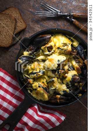Mussels with cheese sauce in a frying pan, napkin Mussels with cheese sauce in a frying pan, napkin 34542911