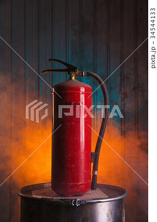 Red fire extinguisher on urban style background Red fire extinguisher on urban style background 34544133