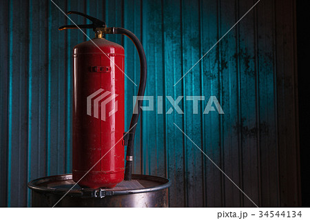 Red fire extinguisher on metal background Red fire extinguisher on metal background 34544134