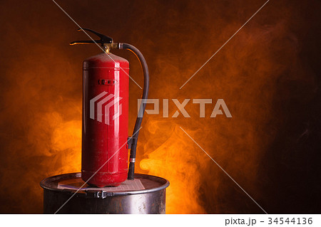 Fire extinguisher on orange smoky background Fire extinguisher on orange smoky background 34544136