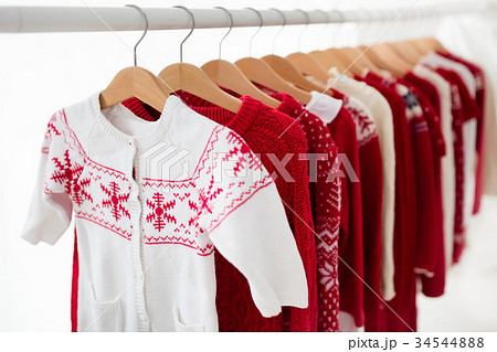 Clothes rack with red Christmas knit wear 34544888