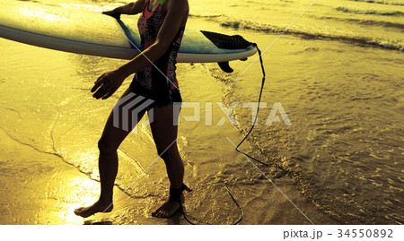 Young woman surfer with surfboard ready to surf 34550892