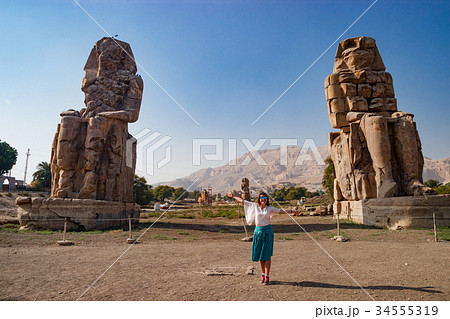 The girl near the ruins of statues in Luxor, Egypt The girl near the ruins of statues in Luxor, Egypt 34555319