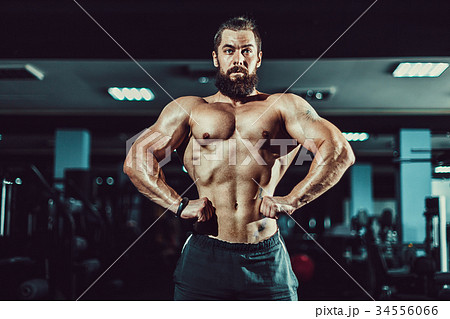 Athlete muscular bodybuilder man posing in gym. Athlete muscular bodybuilder man posing in gym. 34556066