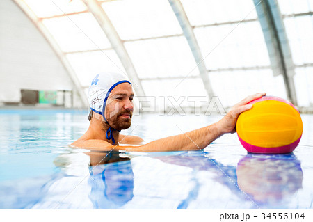 Water polo player in a swimming pool. Water polo player in a swimming pool. 34556104