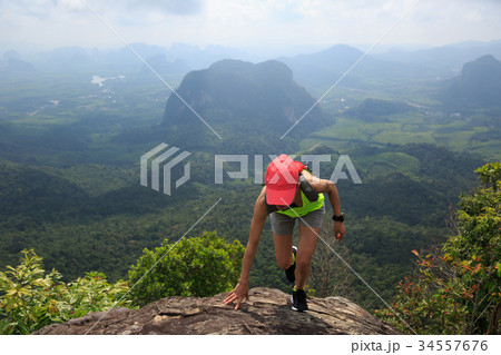 fitness woman trail runner running at mountain top 34557676