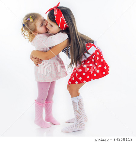 sisters hugging isolated on white background  34559118
