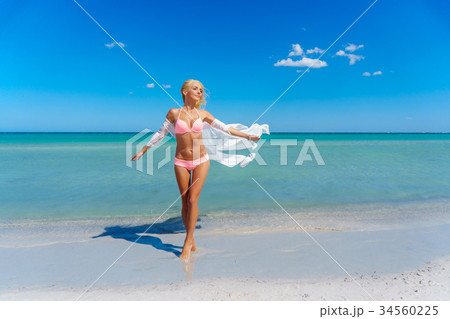 Pretty blonde woman on the beach 34560225