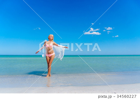 Pretty blonde woman on the beach 34560227
