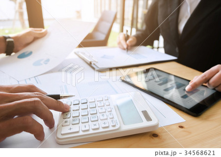 Two business executives discussing data Two business executives discussing data 34568621