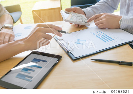 Two business colleagues discussing about data Two business colleagues discussing about data 34568622