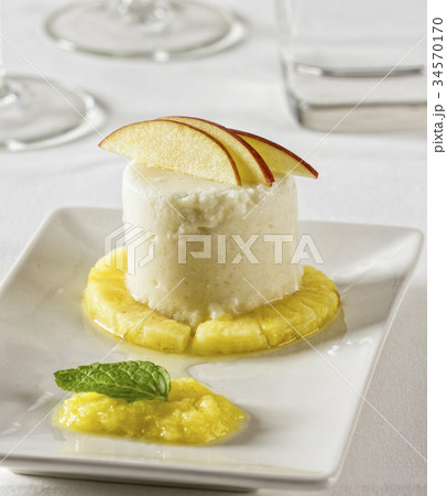 Coconut dessert with pineapple and apple. 34570170