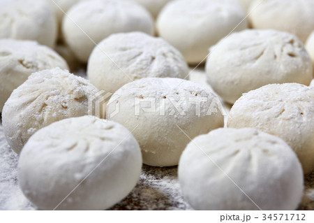 Khinkali on wooden plate with flour. Pelmeni Khinkali on wooden plate with flour. Pelmeni 34571712