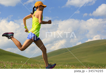 fitness woman trail runner running on mountain fitness woman trail runner running on mountain 34574205