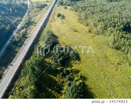 aerial shot of trail in forest landscape 34574923