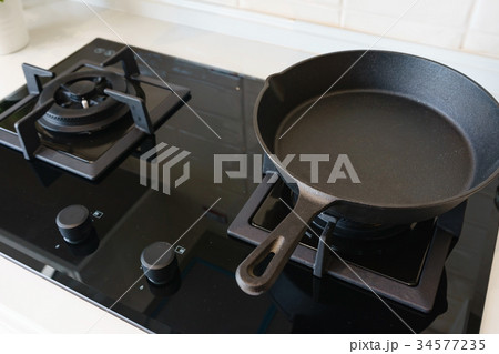 frying pan on gas stove in modern home kitchen. 34577235