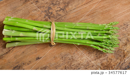 ripe green asparagus on a wooden background 34577617