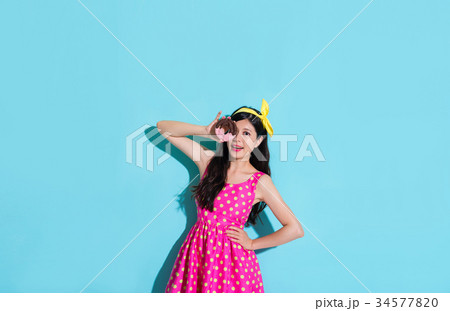beautiful woman holding donut food covered eye beautiful woman holding donut food covered eye 34577820