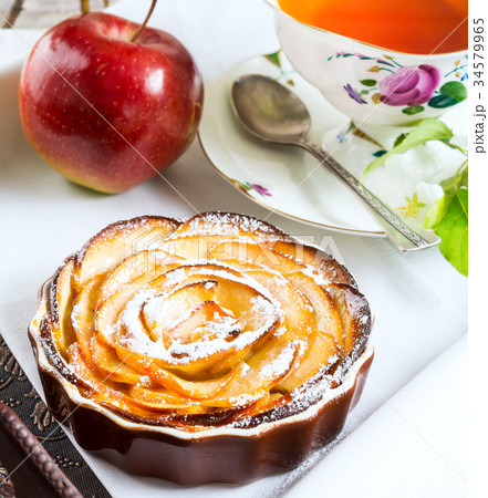 Breakfast tea with sweet apple rose shaped pie 34579965