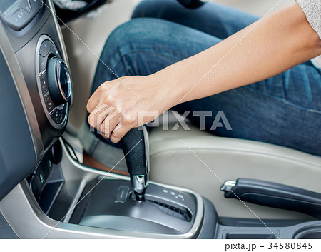woman hand shifting the gear stick woman hand shifting the gear stick 34580845