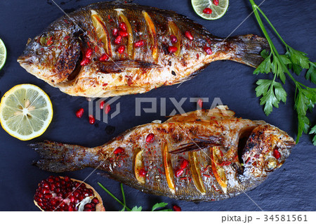 grilled whole fish on slate tray 34581561