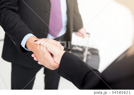 Businessman making handshake with a businesswoman Businessman making handshake with a businesswoman 34585621