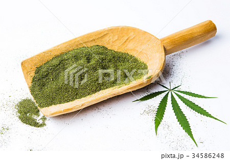 Marijuana powder in a big wooden spoon isolated 34586248
