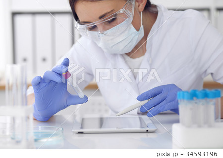 Close-up of professional female scientist in Close-up of professional female scientist in 34593196