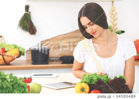 Beautiful Hispanic woman is making online shoppin Beautiful Hispanic woman is making online shoppin 34593489