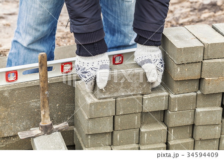 Worker with paving bricks Worker with paving bricks 34594409